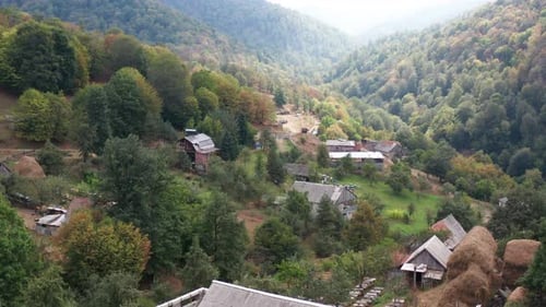 Aerial view small village in green mountain countryside.