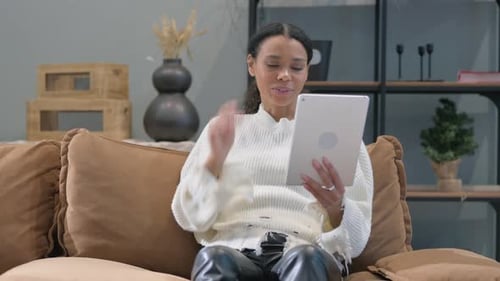 Woman Video Chatting on Tablet on Couch
