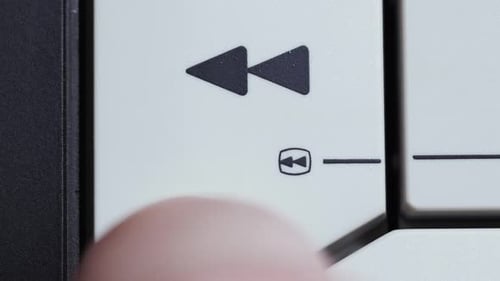 Rewind Button Pressed By Finger On Vintage Controller