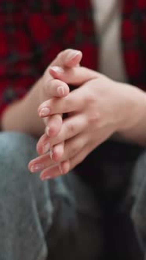 Woman Rubs Palms Sitting on Steps Closeup