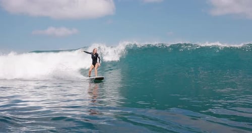 Woman Surfer Rides on the Ocean Wave Beautiful Surfgirl During Surfing