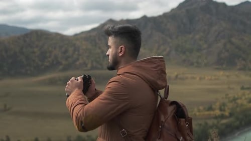 Hiker Tourist Traveler Man with Backpack and Binoculars at Mountain Hiking Travel Landscape Nature