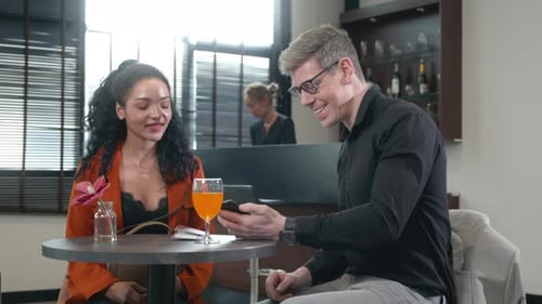 Young Adults in Discussion Looking at Phone