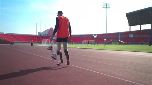 Disabled athletes prepare in starting position ready to run on stadium track