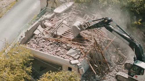 Excavator Demolishing Building in Aerial Shot