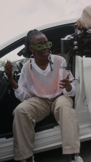 Vertical of Videographer Recording Female Hip-Hop Artist Rapping in Car ...