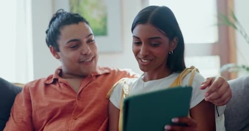 Smiling Couple Relaxing at Home with Tablet