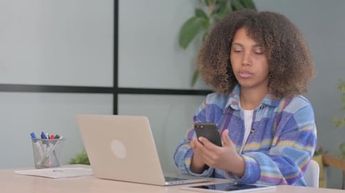 African American Woman Working in Office and Smartphone