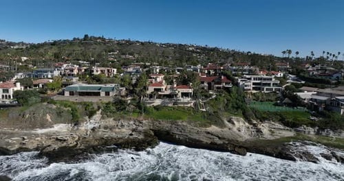 Coastal Homes by Ocean Waves on Sunny Day