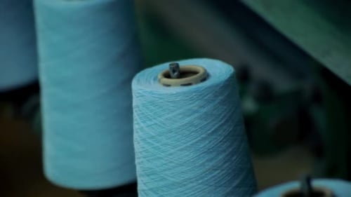 Light Blue Thread Spools on a Textile Machine