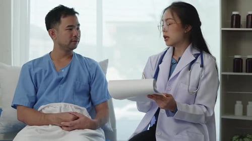 Doctor Explains Chart to Patient in Hospital Room
