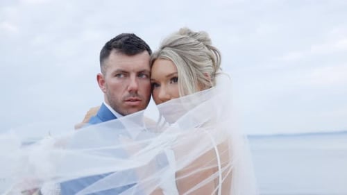 Affectionate Newlyweds Embracing on Beach Wedding Day