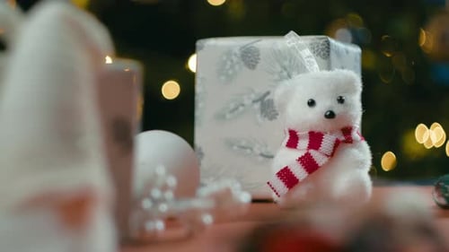 Christmas Teddy Bear Next to a Children's Gift