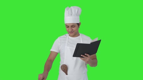 Happy Indian professional chef making food Green screen