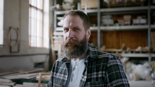 Male Carpenter Standing in Workshop and Looking at Camera. Small Business Concept