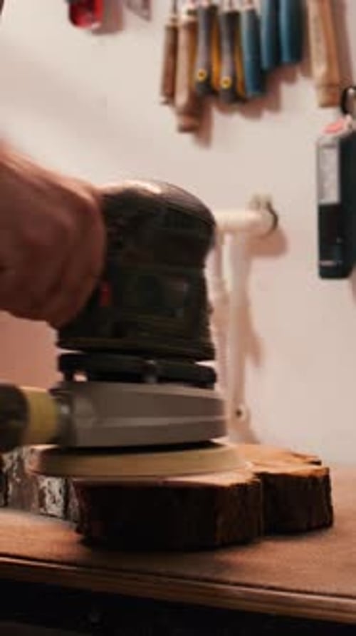 Vertical Video Carpenter Using Angle Grinder on Timber Block to Smooth Surfaces with Sandpaper