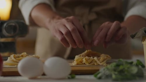 Italian Cuisine, Cooking Master Puts Spaghetti Pasta In Nests In Pile In The Home Kitchen