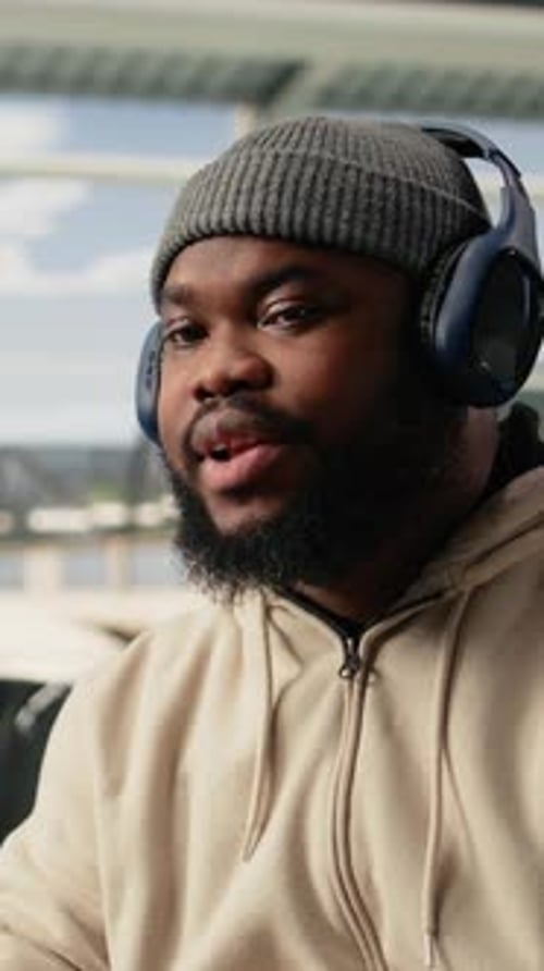 Vertical Video Black Man Vlogger Capturing Live Broadcast on Phone in Airport Terminal
