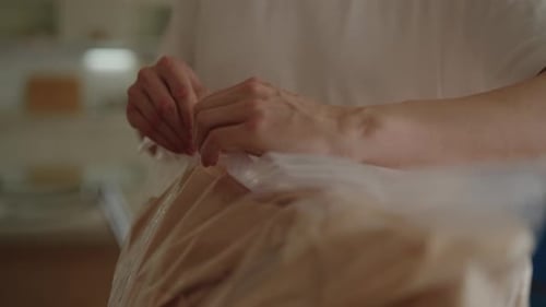 Hands Opening a Food Zipper Bag