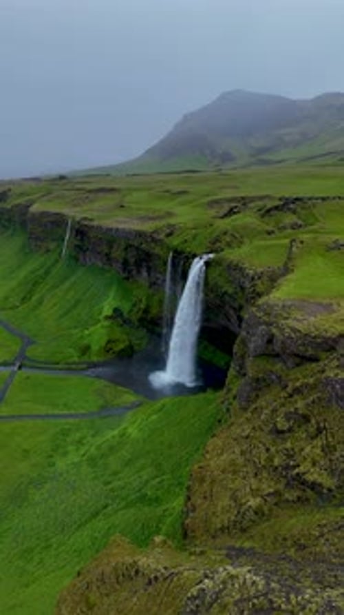Aerial view of green landscape and waterfalls