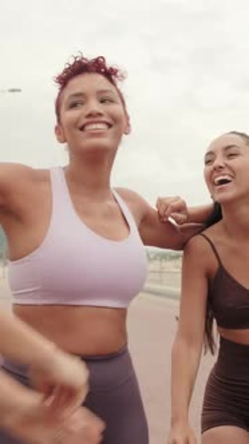 Vertical video, Fitness Friends Celebrate Workout by The Beach