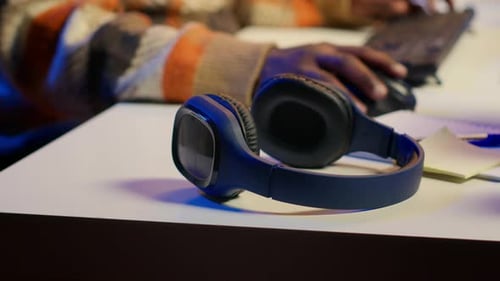 Man Puts on Headphones to Work at Night