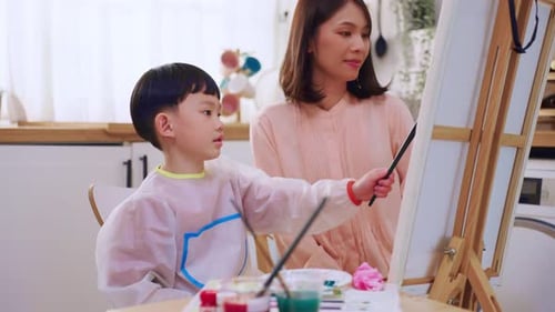 Mother and Child Painting Together at Home