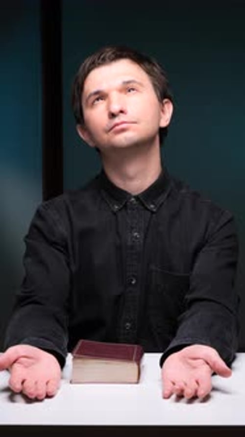 Young Adult with Bible at White Table
