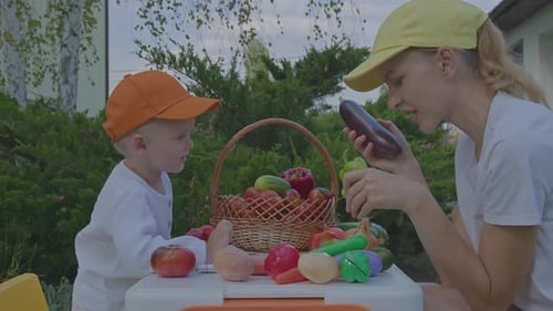 Three Year Old Boy And His Mother Learning Vegetables In Home Garden 2