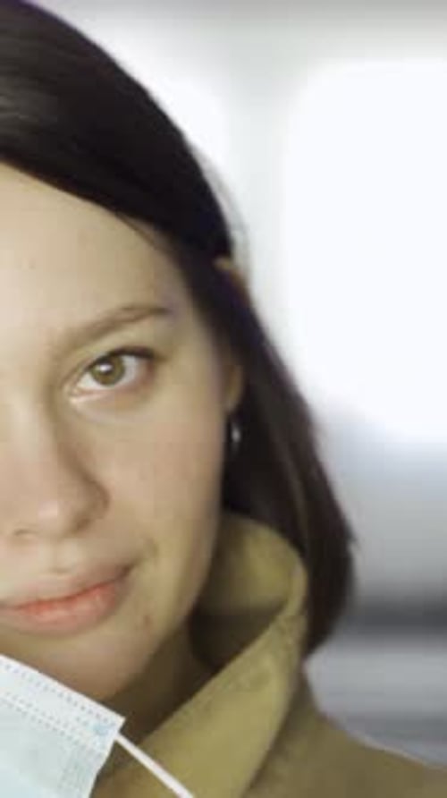 Young Woman Putting on Face Mask in Movie Theater Hall Media Close Up of Brunette Young Girl Putting