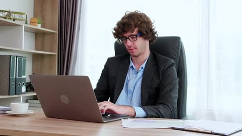 Young caucasian businessman using laptop computer planning for marketing in office.