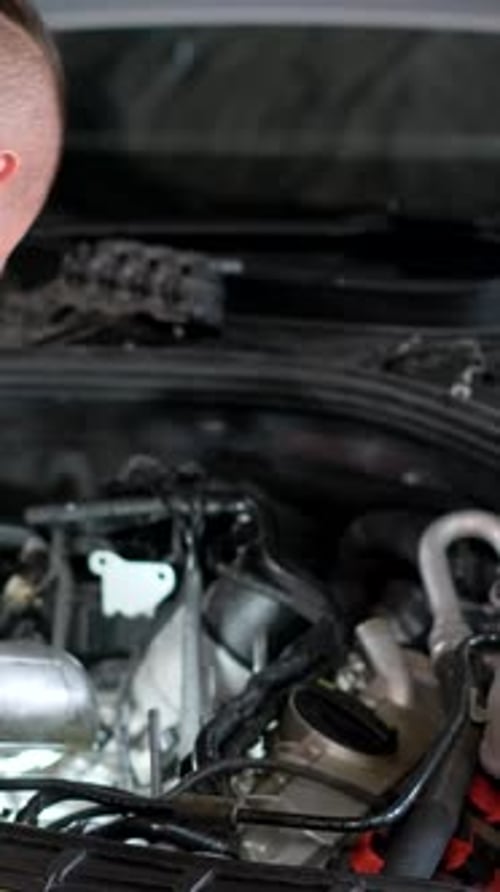 Auto Car Repair Service Center Mechanic Examining Car Engine Vertical Video