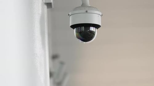 Security camera panning slowly on a wall
