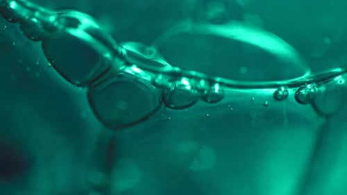Slow Moving Dark Green Bubbles in Abstract Macro Background