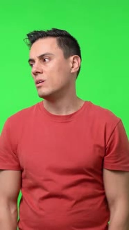 Man Thinking Against a Green Background