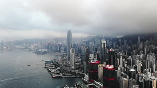 Drone, city and buildings, skyscraper and sea outdoor in urban development at cbd in Hong Kong