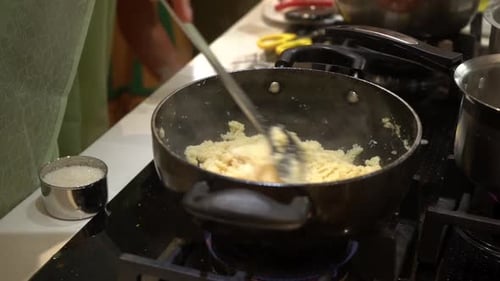 women cooking shira indian sweet dish in pooja rituals Suji ka halwa