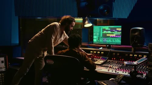 Two Producers Collaborate in Dark Recording Studio