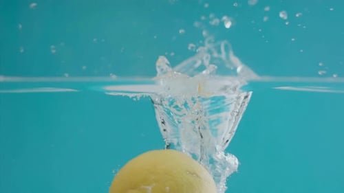 Lemon Splashing into Clear Water Against Blue Background