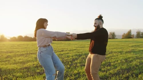 Couple Boy and Girl Spin in the Garden During Valentine's Day