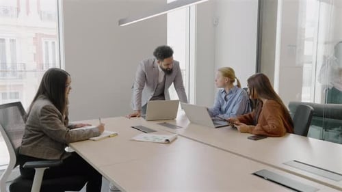 A Diverse Team Working Together and Collaborating Effectively in a Modern Office Setting