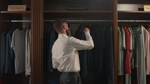 Formally Dressed Man Choosing New Stylish Outfit in Mens Clothing Store