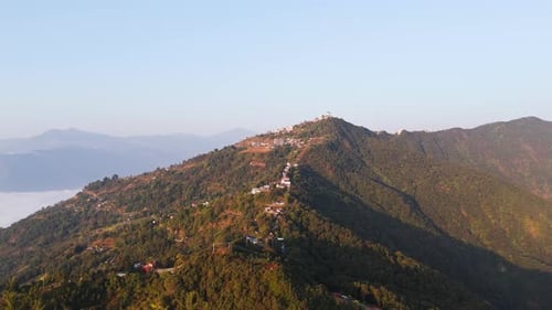 Panoramic drone shot around the Sarangkot hill, hazy sunrise in Pokhara, Nepal