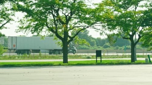 slow motion of a reefer semi tractor and trailer driving on highway
