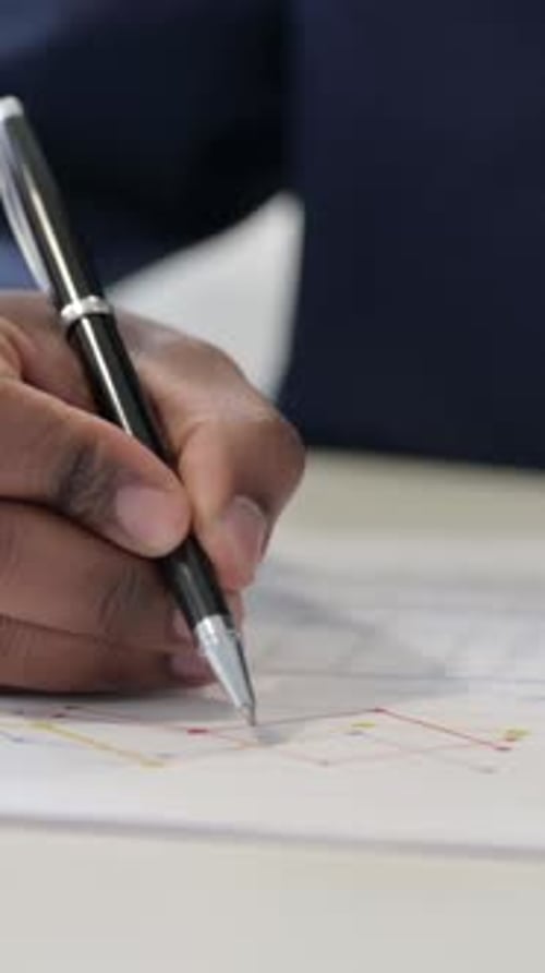 African Businessman Reading Charts on Paper, Close up, Vertical Video