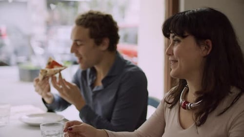 Friends Eating Pizza in Rome Restaurant
