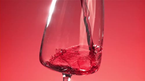 Pouring Red Wine into Glass in Slow Motion