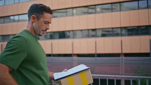 Delivery Guy Carrying Parcel Stepping Street Closeup Man Checking Smartphone