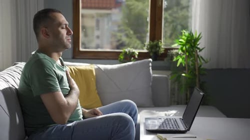 Man Experiencing Chest Pain While Working at Home