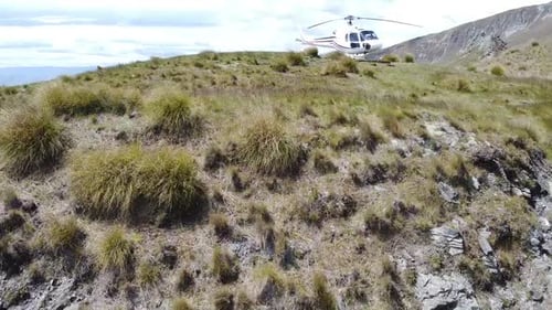 droneshot to showcase the helicopter and the background of the lakes and mountain